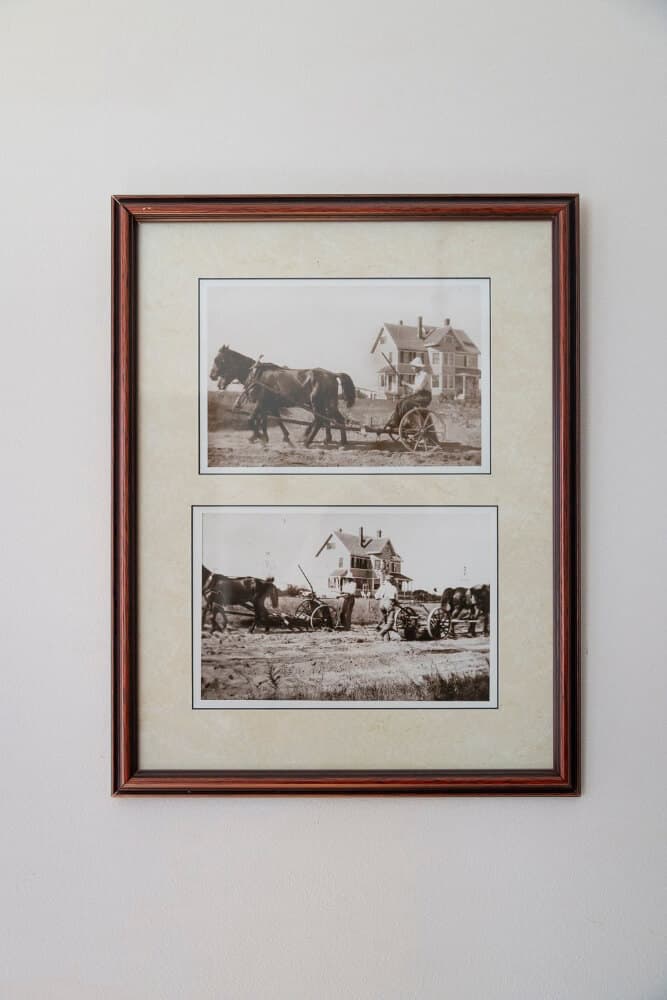 Framed sepia photographs of horses and farmworkers in front of a house.