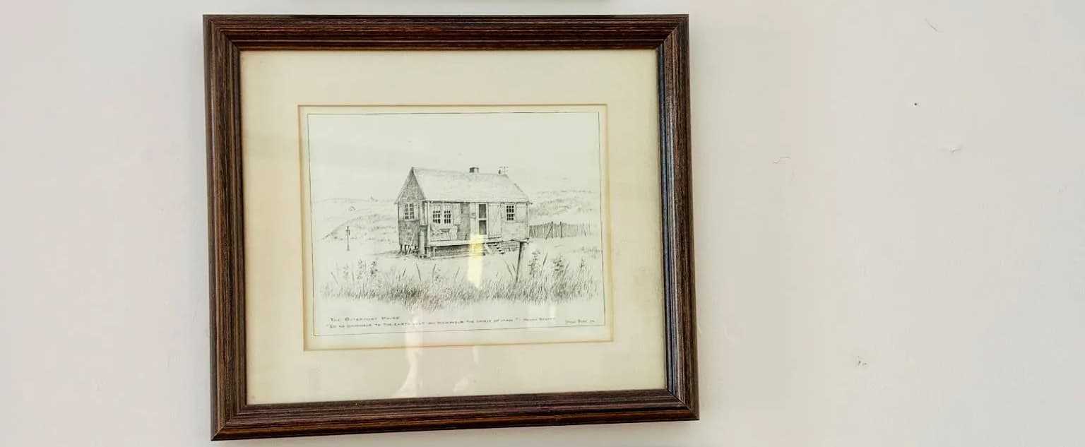 Framed pencil sketch of a simple house in a field. Framed pencil sketch of a simple house in a field.